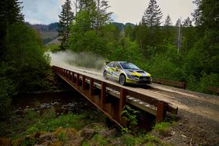 Patrik Sandell racing over a bridge at the scenic Olympus Rally Patrik Sandell racing over a bridge at the scenic Olympus Rally