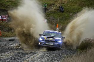 Higgin's 2015 WRX STI plows through a puddle at Wales Rally GB. Constant rain and winds made for a challenging three day rally. Higgin's 2015 WRX STI plows through a puddle at Wales Rally GB. Constant rain and winds made for a challenging three day rally.